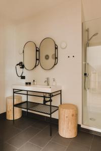 a bathroom with a sink and two mirrors at Osada Matygówka in Gliczarów