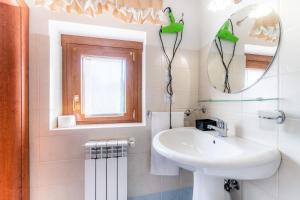 a white bathroom with a sink and a mirror at B&B Capriccio in Rocca Priora