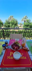 a table with a plate of food on it at Rainbow Seafront Apartment in Praia a Mare +26 photos