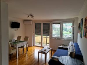 a living room with a couch and a table at Apartman BELAMAR in Duga Resa