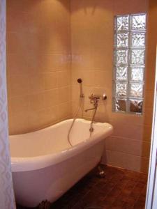 a white bath tub in a bathroom with a window at Patalaiska Villas in Ruokolahti