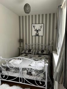 a bedroom with a bed with a deer head on the wall at The nook 21a mill street in Kington