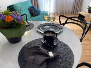 a table with two glasses of wine on top of it at OKO NA ZATOKĘ in Puck +11 photos