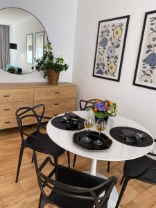 a white table with two chairs and a mirror at OKO NA ZATOKĘ in Puck