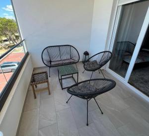 balcón con 3 sillas, mesa y silla en Apartman J&M en Makarska