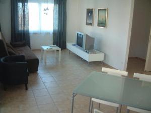 a living room with a couch and a tv at Peter Hart Wohnen auf Zeit - mit Komfort in Filderstadt