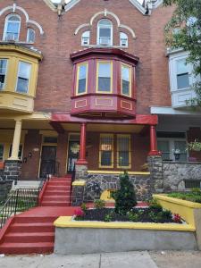 a large brick building with a red and yellow house at Reservoir Hill Mansion - 4 bedrooms in Baltimore