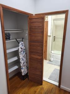 a bathroom with a closet with a surfboard in it at Reservoir Hill Mansion - 4 bedrooms in Baltimore