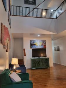 a living room with a couch and a flat screen tv at Reservoir Hill Mansion - 4 bedrooms in Baltimore