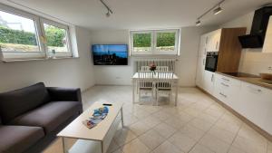 a living room with a couch and a table at Komfortable & moderne Ferienwohnung in Markdorf - Familie Hildebrand in Markdorf