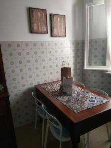 a table with two chairs and a box on it at Appartamento Da Castlin in Fano +32 photos