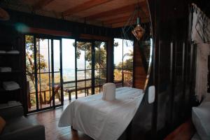 a room with a bed with a view of the ocean at Waira Eco Lodge in Villavicencio