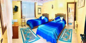 Giường trong phòng chung tại Gite Karima