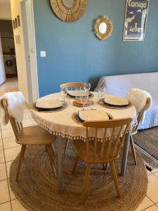 a table with chairs and plates and wine glasses on it at Gite Le Canigou 3* dans un Mas typique catalan in Prades