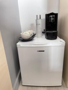 a coffee maker on top of a white refrigerator at Les Embruns in Trouville-sur-Mer