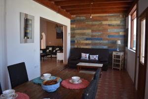 a living room with a couch and a table at Villa Experience Heated Salty Water Pool in Caleta De Fuste