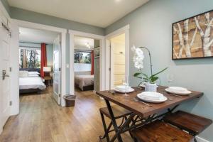 a dining room with a table and a bedroom at Fresh and Airy Condo in downtown Breck! in Breckenridge