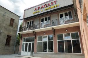 an apartment building with a balcony on top of it at ARAGAST HOTEL & BREWERY пивоварня in Sevan