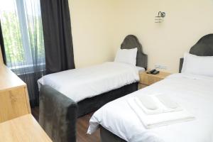 Voodi või voodid majutusasutuse Aragast Hotel & Brewery toas