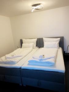 two beds in a room with towels on them at Cozy Apartment Bernburg 3 in Roschwitz