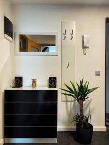 a bathroom with a black dresser and a mirror at Cozy Apartment Bernburg 3 in Roschwitz