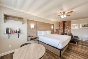 Habitación de hotel con 1 cama y 2 mesas en Harbor House Inn, en Morro Bay