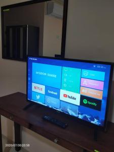 a flat screen tv sitting on top of a wooden table at TAMIM SUITE GROUP HOTEL Dungun in Dungun