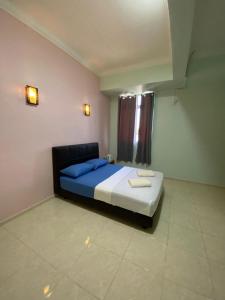 TAMIM SUITE GROUP HOTEL Dungun客房内的一张或多张床位
