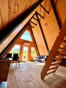 a large attic room with a large window at Blackcherry_Ukraine in Chereshenka