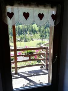 a window with a view of a park at Residence Pavou in Cogne