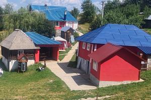 un grupo de pequeñas casas con techos azules en Vila Medo en Nova Varoš