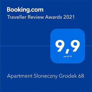a blue square with the words travel review awards on it at Apartment Sloneczny Grodek 68 in Gródek Nad Dunajcem
