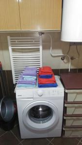 a washing machine with colorful towels on top of it at apartment24 in Skopje