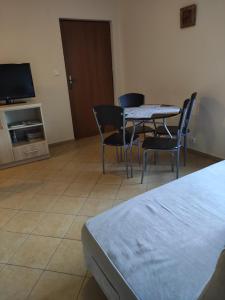 Camera con tavolo, sedie e TV di Domek pod brzozami a Grzybowo