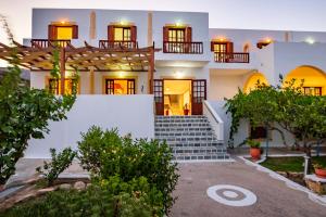 a large white house with stairs in front of it at Casa Garden in Karpathos