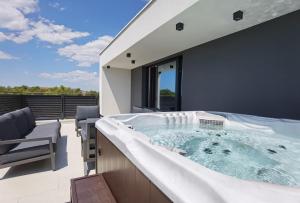 a hot tub on the roof of a house at Villa Emperor in Srima