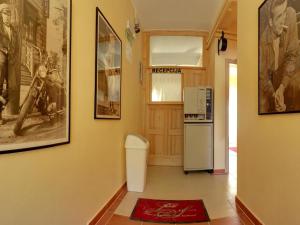 a hallway with a refrigerator and pictures on the wall at Cinema House Single & Double Rooms & Studio Apartments in Pula