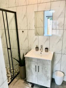 a bathroom with a sink and a mirror at URRR Casa on Msasa in Randburg