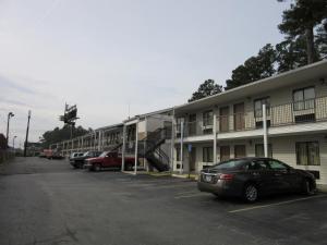 a car parked in a parking lot next to a building at Heritage Inn Augusta in Augusta