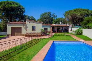 a villa with a swimming pool in front of a house at Villa Del Sol in Santa Cristina d'Aro