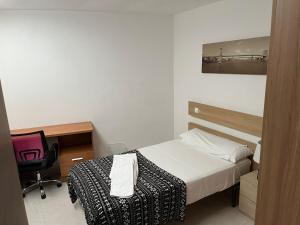 Łóżko lub łóżka w pokoju w obiekcie Residencia Vista Alegre