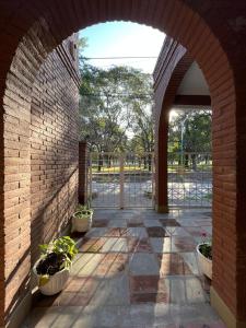 an archway in a brick building with potted plants at Casa Frente Parque Guillermina in San Miguel de Tucumán