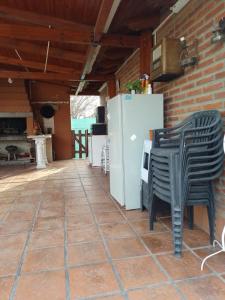 a patio with two chairs and a refrigerator at Mi casa in Salta