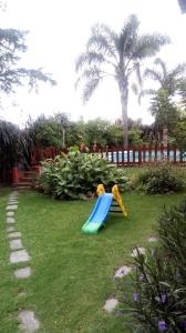 a playground with a slide in the grass at Mi casa in Salta