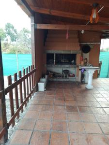 a porch of a house with a fireplace at Mi casa in Salta