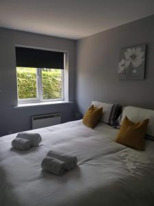 een groot wit bed met 2 kussens erop bij Green Street Retreat in York