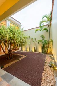 a hallway with palm trees and a building at XTILU Hotel - Adults only - in Oaxaca City