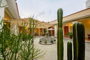a courtyard with a cactus in front of a building at XTILU Hotel - Adults only - in Oaxaca City
