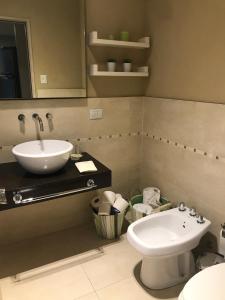 a bathroom with a sink and a toilet at Departamento en La Bahia de Nordelta in Benavídez