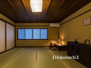 an empty room with a window and a table at Kyoisuke in Kyoto